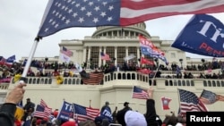 Supporters of U.S. President Donald Trump occupy the U.S. Capitol Building in Washington, U.S., January 6, 2021. Thomas P. Costello/USA TODAY via REUTERS NO RESALES. NO ARCHIVES