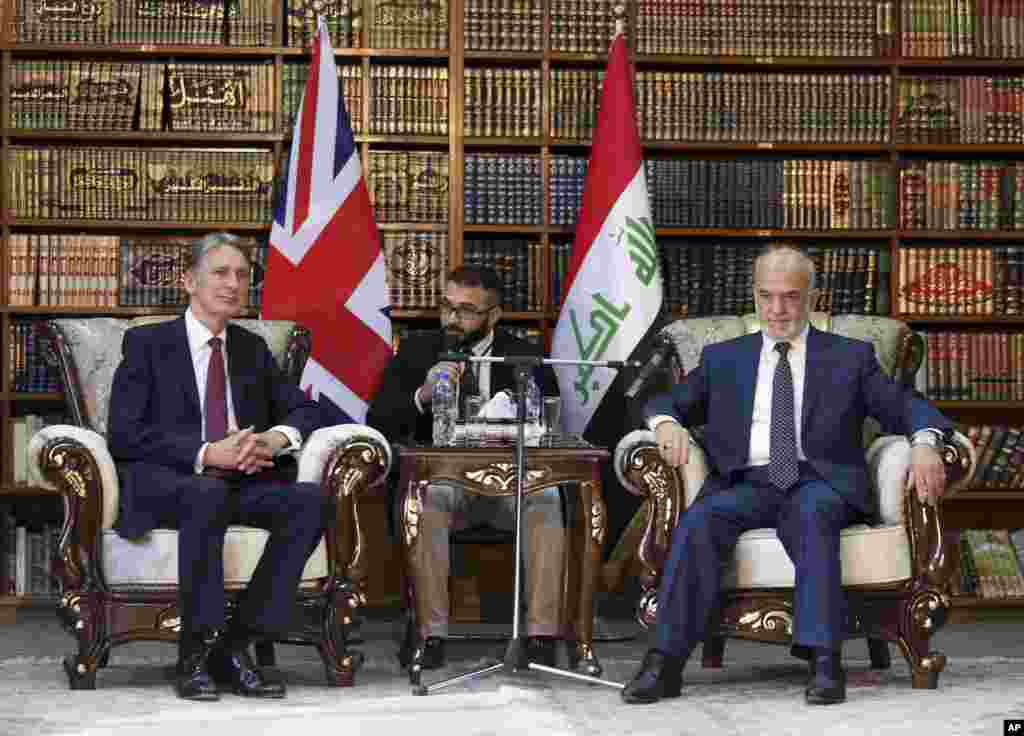 Britain's Foreign Secretary Philip Hammond, left, in a meeting with his Iraqi counterpart Ibrahim al-Jaafari, in Baghdad, Iraq, Monday, Oct. 13, 2014. Hammond said coalition airstrikes will not be enough to defeat the Islamic State group, though he also ruled out the use of foreign ground forces.