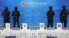 FILE - Police officers stand behind seized crystal methamphetamine during a news conference in Bangkok, Thailand, May 29, 2023. Law enforcement officials said they seized more than a ton of crystal methamphetamine that they believed was bound for Australia.