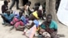 FILE - Residents displaced by fighting between government and rebel forces are seen at a World Food Program (WFP) outpost in Kuernyang Payam, South Sudan, May 2, 2015. 