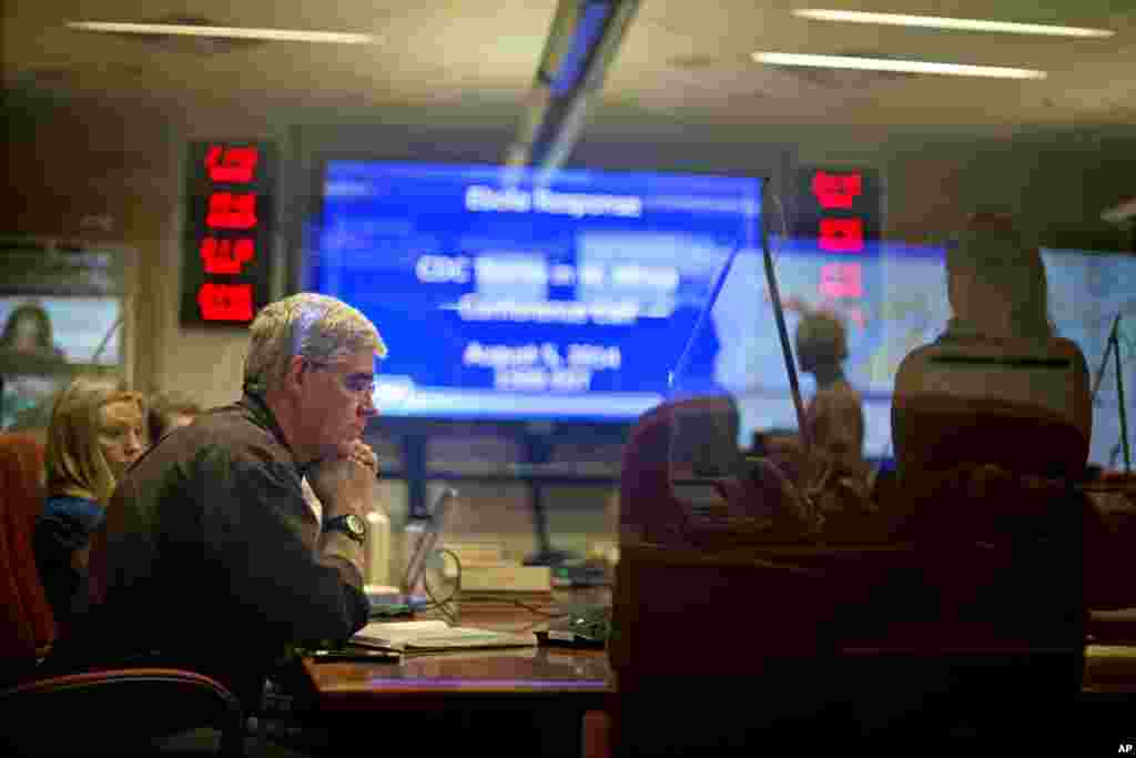 At the U.S. Centers for Disease Control and Prevention officials are on a conference call with CDC team members deployed in West Africa from the agency's Emergency Operations Center, Aug. 5, 2014, in Atlanta.