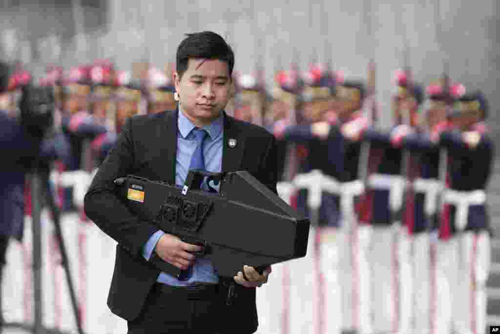 A security detail member of Vietnam's President Luong Cuong holds a drone shield during a welcoming ceremony at the Palace of Justice, on the sidelines of the Asia-Pacific Economic Cooperation (APEC) summit, in Lima, Peru.