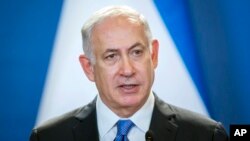 FILE - Israeli Prime Minister Benjamin Netanyahu speaks during a joint press conference with his Hungarian counterpart, Viktor Orban, in the Parliament building in Budapest, Hungary, July 18, 2017.