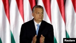Hungarian Prime Minister Viktor Orban applauds as he presents the program of his Fidesz party for European Parliament elections in Budapest, Hungary, April 5, 2019.