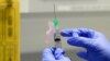 FILE - A clinical research nurse prepares the COVID-19 vaccine to administer to a volunteer, at a clinic in London, Aug. 5, 2020. (AP)