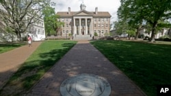FILE - A sidewalk leads to the South Building on campus at The University of North Carolina in Chapel Hill, N.C., April 20, 2015.