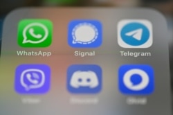 FILE - This picture taken on Jan. 22, 2021 in Rennes, France, shows a smartphone screen featuring messaging service applications WhatsApp, Signal, telegram, Viber, Discord and Olvid.