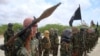 Al-Shabaab fighters display weapons as they conduct military exercises in northern Mogadishu, Somalia, Oct. 21, 2010.
