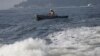 A man fishes on the Guanabara Bay in Rio de Janeiro, Brazil, Thursday, April 10, 2014. Many had hoped authorities tackle decades of neglect and poor planning that have blighted waterways, after Rio's Olympic committee pledged in writing that the pollution