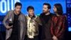 Dan Reynolds, from left, Ben McKee, Daniel Platzman, and Daniel Wayne Sermon of Imagine Dragons accept the award for favorite duo or group at the American Music Awards at the Microsoft Theater in Los Angeles, Nov. 19, 2017.