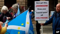 Protesters holding a Scottish flag with European stars gather in front of the Scottish Court of Session in Edinburgh, Scotland, Wednesday, Sept 4, 2019. A Scottish court says British Prime Minister Boris Johnson's planned suspension of Parliament is…