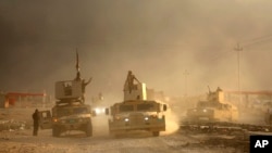 An Iraqi military convoy advances toward the city of Mosul, Iraq, Oct. 19, 2016. 