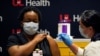 LaShawn Scott, a nurse at University of Louisville Hospital, is inoculated with the Pfizer coronavirus disease (COVID-19) vaccine at The University of Louisville Hospital in Louisville, Kentucky, December 14, 2020.
