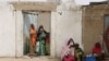 Des femmes regardent passer des militaires à Kerawa, à la frontière du Nigeria où Boko Haram frappe, au Cameroun, le 16 mars 2016.