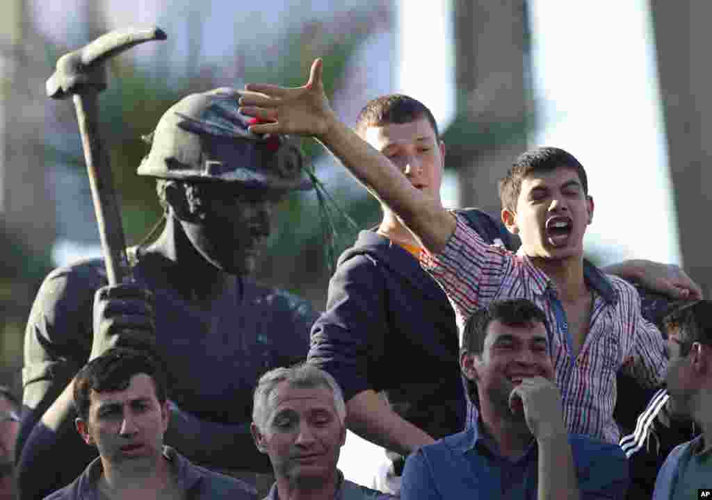 Hundreds of protesters took part in a march against the government. Some protesters chanted slogans near a monument for the town's miners, Soma, May 16, 2014. 