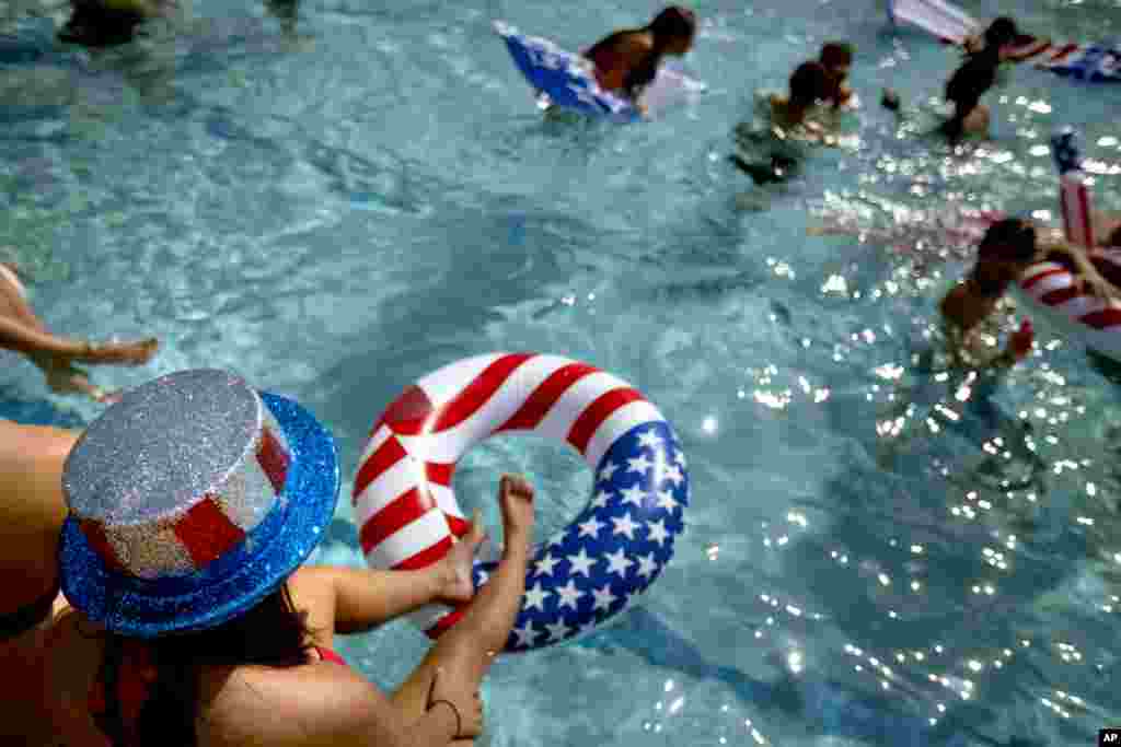 Freshman Shannon Anderson, 19, sits on the edge of the pool during a party outside the debate hall ahead of the presidential debate between Republican presidential candidate Mitt Romney and President Barack Obama, at Lynn University October 22, 2012, in
