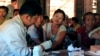 FILE - A government health worker takes a blood sample from a woman to be tested for malaria in Ta Gay Laung village hall in Hpa-An district in Kayin state, southeastern Myanmar, Nov. 28, 2014.
