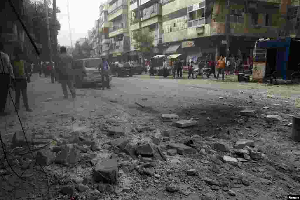 Debris is seen on the ground after what activists said was shelling by forces loyal to Syria's President Bashar al-Assad in the al-Myassar neighborhood of Aleppo, Sept. 19, 2013.