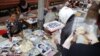 Vendors sell pictures of the royal family, as the country prepares for the funeral of Cambodia's late King Norodom Sihanouk, near the Royal Palace in Phnom Penh, January 31, 2013. 