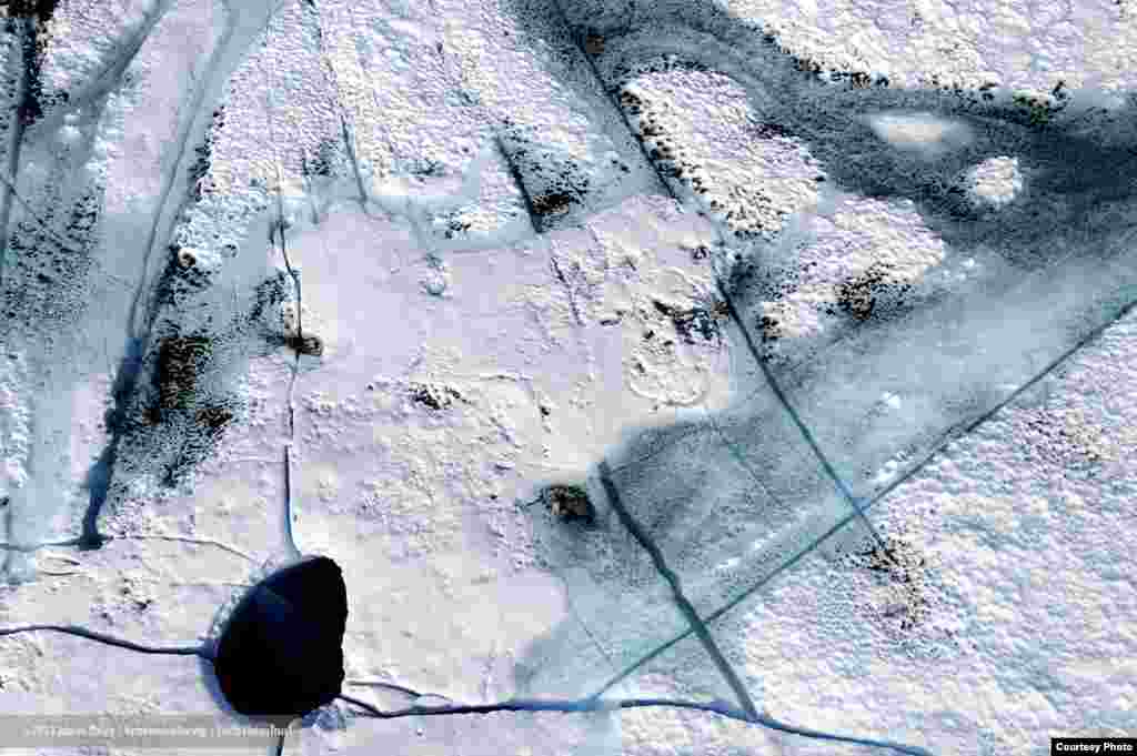 On Greenland’s ice sheet, silt and soot blown from afar absorb solar heat and melt down into the ice. (James Balog/Extreme Ice Survey)