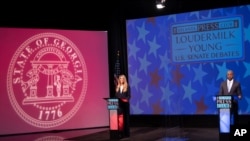 Sen. Kelly Loeffler, left, and Democratic challenger for U.S. Senate Raphael Warnock appear during a debate, Dec. 6, 2020, in Atlanta. 