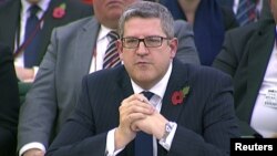 FILE - Andrew Parker, head of M15, is seen attending an Intelligence and Security Committee hearing at Parliament, in this still image taken from video in London, Nov. 7, 2013. 