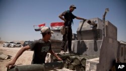 Iraqi counterterrorism forces load a Humvee with rockets to take to a front line position in their fight to oust Islamic State militants from Fallujah, Iraq, June 7, 2016.