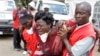 Red Cross staff console a woman after she viewed the body of a relative killed in Thursday's attack at a university in Garissa northeastern Kenya, at Chiromo funeral home, Nairobi, Kenya, Tuesday, April 7, 2015. Al-Shabab gunmen rampaged through a university in northeastern Kenya at dawn Thursday, killing scores of people in the group's deadliest attack in the East African country. (AP Photo/Khalil Senosi)