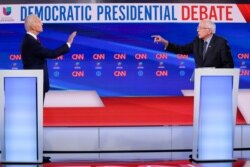 FILE - Former Vice President Joe Biden, left, and Sen. Bernie Sanders, I-Vt., right, participate in a Democratic presidential primary debate at CNN Studios in Washington, March 15, 2020.