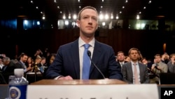 Facebook CEO Mark Zuckerberg arrives to testify before a joint hearing of the Commerce and Judiciary Committees on Capitol Hill in Washington, April 10, 2018, about the use of Facebook data to target American voters in the 2016 election.