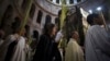 Christian clergy and worshipers hold palm fronds during a procession in the Church of the Holy Sepulcher in Jerusalem's Old City March 24, 2013.