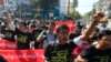 FILE - Reporters shout as they march demanding broader press freedom in Yangon, Myanmar, Jan. 7, 2014.