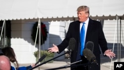 FILE - President Donald Trump speaks with reporters before boarding Marine One on the South Lawn of the White House, Dec. 7, 2019, in Washington. 