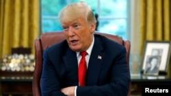 FILE - U.S. President Donald Trump answers a question during an interview with Reuters in the Oval Office of the White House in Washington, Aug. 20, 2018. 