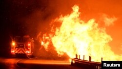 Petugas pemadam kebakaran berusaha memadamkan api di utara Los Angeles, California, AS, 25 Oktober 2019. (Foto: Reuters/Gene Blevins)