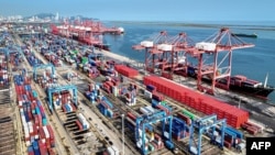 FILE - Shipping containers and gantry cranes are seen at a port in Lianyungang, in eastern China's Jiangsu province, on Aug. 7, 2024.