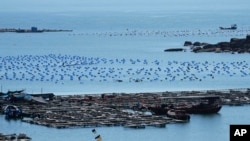 FILE - A boat moves through the water at the 68-nautical-mile scenic spot, the closest point in mainland China to the island of Taiwan, in Pingtan in southeastern China's Fujian Province, on Aug. 5, 2022. 
