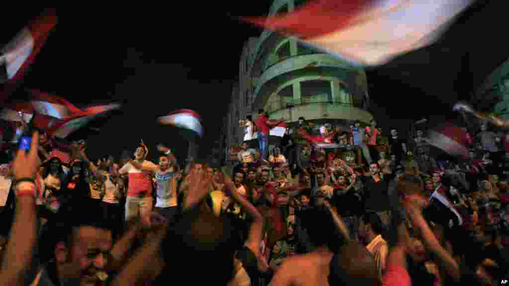 Opponents of Egypt's ousted president Mohamed Morsi celebrate outside the presidential palace in Cairo, July 3, 2013.