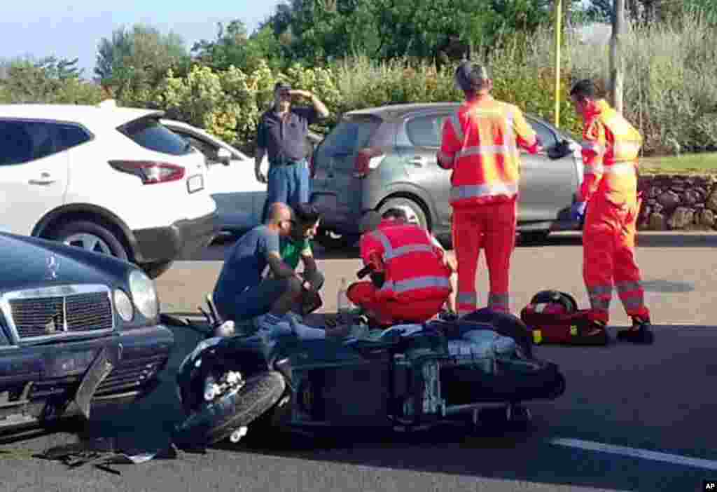 Ambulance personnel tend to a man lying on the ground, later identified as actor George Clooney, after he was involved in a motor scooter accident near Olbia, on Sardinia island, Italy. Clooney was taken to the hospital in Sardinia and released, hospital officials said. “He is recovering at his home and will be fine,” spokesman Stan Rosenfield told The Associated Press in an email.