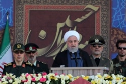 President Hassan Rouhani speaks at a military parade marking 39th anniversary of outset of Iran-Iraq war, in front of the shrine of the late revolutionary founder Ayatollah Khomeini, just outside Tehran, Sept. 22, 2019.