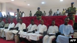 A picture taken Aug. 26, 2015 shows suspected members of Boko Haram sitting in court in N'Djamena.