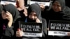 Filipino Muslims display messages during a rally at the Lower House to call for the passage of Bangsamoro Basic Law, or BBL, in Quezon city, northeast of Manila, Tuesday, Feb. 10, 2015.