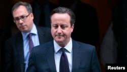 FILE - Britain's Prime Minister David Cameron leaves 10 Downing Street in London. Cameron's office has vowed to 'look into' the case of a British Muslim family being denied entry to the US.