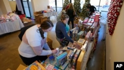Workers arrange toys at The Toy Store, a free-referral based toy store on December 7, 2023, in Nashville, Tenn.(AP Photo/Mark Humphrey)