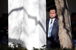 FILE - White House Social Media Director Dan Scavino listens to President Donald Trump speak during an event in the Rose Garden at the White House, Feb. 15, 2019.