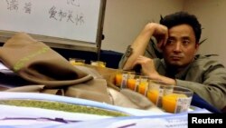 A relative of a passenger onboard Malaysia Airlines Flight MH370 sits inside a prayer room at Lido Hotel in Beijing, May 2, 2014. 