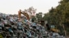 A bulldozer moves piles of garbage in Karantina, east Beirut, Lebanon, Nov. 1, 2015.