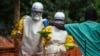 FILE - Medical staff working with Medecins Sans Frontieres (Doctors Without Borders) prepare to take food to patients in the isolation area of an Ebola treatment center in Sierra Leone's Kailahun district, July 20, 2014.