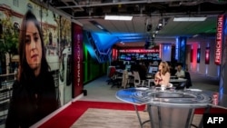FILE - Journalist Belle Donati is seen on a TV set of the new headquarters of the multilingual news television channel Euronews in Lyon's Confluence district, southeastern France.