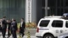 FILE - A police vehicle is seen parked outside a building in Beijing, July 9, 2015.